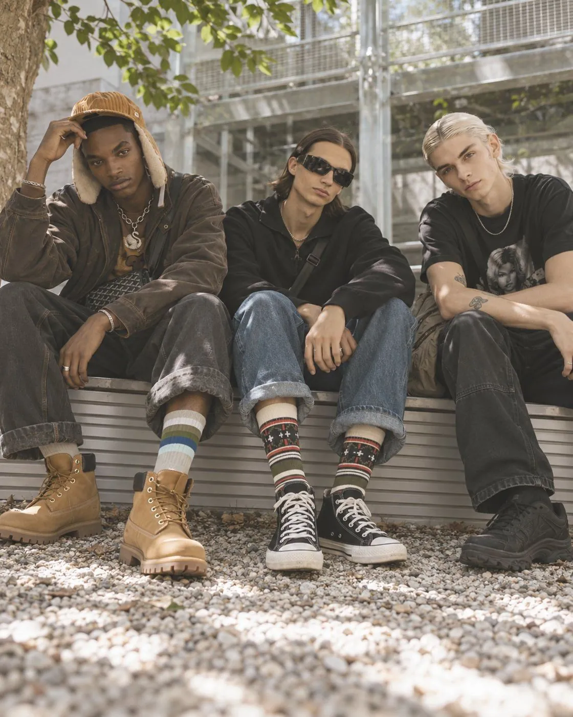 Group of friends wearing colorful TAKIA crew socks in a sunny courtyard