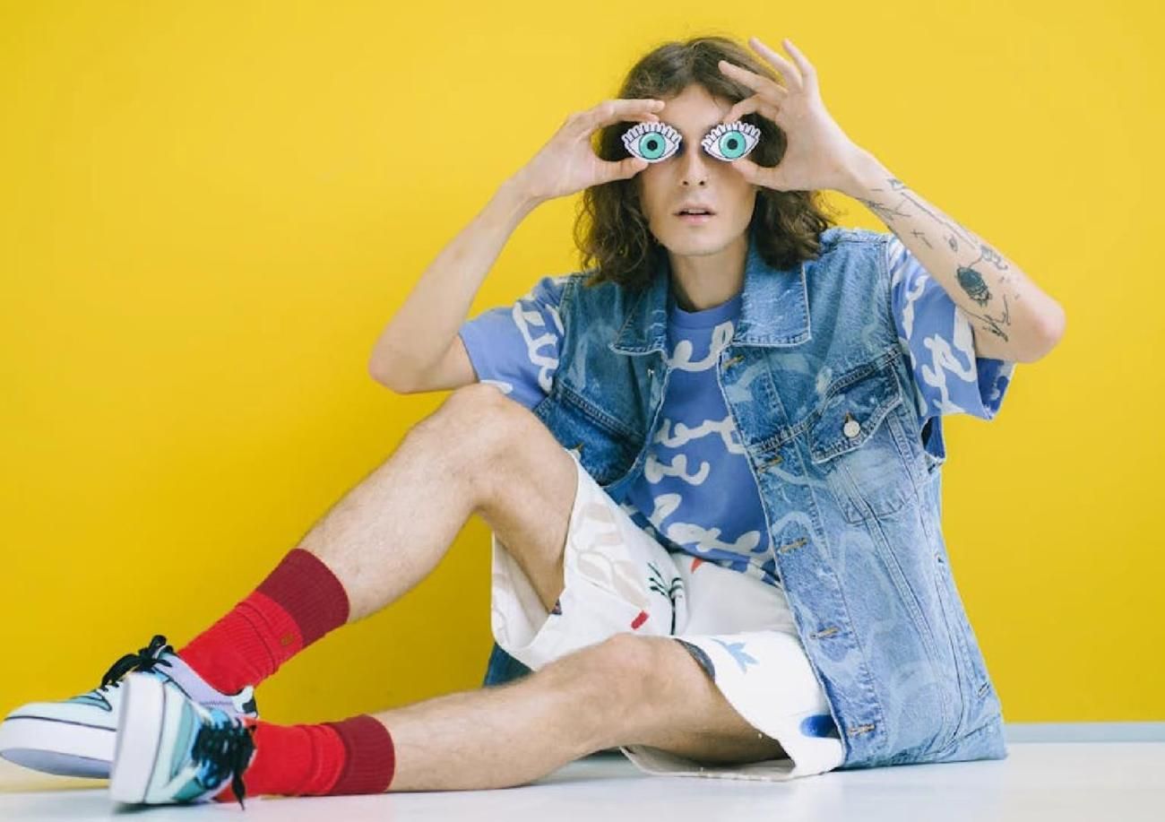 Model on a yellow backdrop in red TAKIA socks